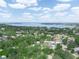 An aerial view of a neighborhood by a lake, with homes surrounded by lush trees on a sunny day at 509 Mountain Dr, Babson Park, FL 33827