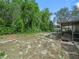 View of the spacious backyard with large trees at 509 Mountain Dr, Babson Park, FL 33827