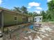 View of screened lanai and the backyard with storage shed at 509 Mountain Dr, Babson Park, FL 33827