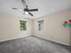 Bedroom featuring neutral walls, carpet flooring, two windows, and a ceiling fan at 509 Mountain Dr, Babson Park, FL 33827