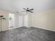 Bedroom featuring neutral walls, carpet flooring, and a door leading to the ensuite bathroom at 509 Mountain Dr, Babson Park, FL 33827