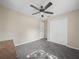 Bedroom with light walls, carpet flooring, a ceiling fan, and double door closet at 509 Mountain Dr, Babson Park, FL 33827