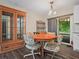 Cozy dining area with wood floors, a display cabinet, a table and chairs, and sliding doors to the patio at 509 Mountain Dr, Babson Park, FL 33827