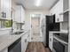 Modern kitchen with white cabinets, granite countertops, stainless steel appliances, and wood floors at 509 Mountain Dr, Babson Park, FL 33827