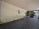 View of the enclosed back patio with a concrete surface and view of the backyard at 509 Mountain Dr, Babson Park, FL 33827