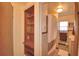 Quaint bathroom features a pink tub, shower curtain, vintage tiles, and built-in shelving at 509 N Scenic Hwy, Frostproof, FL 33843