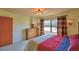 Bedroom with carpet floors, a view to the outside, warm lighting and neutral wall color at 509 N Scenic Hwy, Frostproof, FL 33843