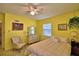 Inviting bedroom with yellow walls, carpet, ceiling fan, vintage decor, and plenty of natural light at 509 N Scenic Hwy, Frostproof, FL 33843