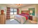 Bedroom with neutral walls, natural light, carpet floor, wood accents, and a comfortable-looking bed at 509 N Scenic Hwy, Frostproof, FL 33843
