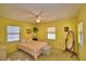 Bright bedroom featuring yellow walls, carpet, ample natural light, and vintage decor at 509 N Scenic Hwy, Frostproof, FL 33843