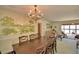 Spacious dining room featuring a scenic wall mural and a large dining table at 509 N Scenic Hwy, Frostproof, FL 33843