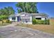 Charming single-story home featuring a well-maintained lawn, mature trees, and an American flag at 509 N Scenic Hwy, Frostproof, FL 33843
