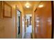 Hallway with carpet floor and light-colored walls, doors to different rooms, and a closet at 509 N Scenic Hwy, Frostproof, FL 33843