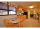 Eat-in kitchen featuring maple cabinets, a breakfast table, and a large window for natural light at 509 N Scenic Hwy, Frostproof, FL 33843