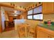 Charming eat-in kitchen featuring maple cabinets, tile floors, and an adjacent living area at 509 N Scenic Hwy, Frostproof, FL 33843