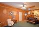 Inviting living room with wood paneling, a white chair, and a brown leather sofa at 509 N Scenic Hwy, Frostproof, FL 33843