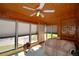 Inviting sunroom with wood paneling, large windows, and comfortable seating at 509 N Scenic Hwy, Frostproof, FL 33843