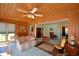 Bright sunroom with wood-paneled walls, multiple windows, and comfortable seating at 509 N Scenic Hwy, Frostproof, FL 33843