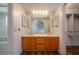 This bathroom includes a double vanity, large mirror, and walk-in closet for plenty of storage at 6201 Country Club Dr # 21, Lake Wales, FL 33898
