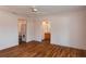 Bright bedroom with wood floors, an arched doorway, and a convenient laundry area at 6201 Country Club Dr # 21, Lake Wales, FL 33898