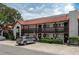 Inviting two-story condo building boasting a red tile roof and charming exterior with a parking area at 6201 Country Club Dr # 21, Lake Wales, FL 33898