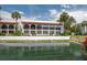 Exterior shot of the building complex, overlooking a canal on a sunny day with blue sky and palm trees at 6201 Country Club Dr # 21, Lake Wales, FL 33898
