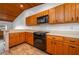 Cozy kitchen boasting wood cabinets, a black oven, and plenty of countertop space at 6201 Country Club Dr # 21, Lake Wales, FL 33898