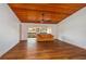 Bright living room featuring wood floors, wood ceiling, and comfortable leather sofa with balcony view at 6201 Country Club Dr # 21, Lake Wales, FL 33898