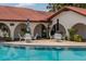 Community pool with poolside seating and umbrellas at 6201 Country Club Dr # 21, Lake Wales, FL 33898