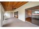 Enclosed sunroom with wood plank ceiling, fan, carpet, and sliding doors to balcony with wood-look flooring at 6201 Country Club Dr # 21, Lake Wales, FL 33898