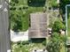 Aerial perspective showcasing a well-maintained roof, green surroundings, and driveway of the property at 7 Lamplight Ln, Winter Haven, FL 33884