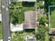 Overhead shot of a home showing the roof, yard, and surrounding neighborhood, offering a sense of location at 7 Lamplight Ln, Winter Haven, FL 33884