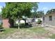 An outdoor living space with lawn, mature trees, and shed is ready for relaxation or entertaining at 7 Lamplight Ln, Winter Haven, FL 33884