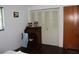 Bedroom with a desk, chair, shutter door closet and brown door at 7 Lamplight Ln, Winter Haven, FL 33884