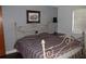 Bedroom with a plaid bedspread, window, side table, lamp and framed art at 7 Lamplight Ln, Winter Haven, FL 33884
