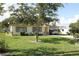 Charming single-story home featuring a well-maintained lawn and convenient covered carport at 7 Lamplight Ln, Winter Haven, FL 33884