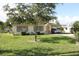 Charming single-story home featuring a well-maintained lawn and convenient covered carport at 7 Lamplight Ln, Winter Haven, FL 33884