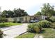 A quaint single-story house featuring a covered carport and a well-kept front yard with shrubs at 7 Lamplight Ln, Winter Haven, FL 33884