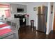 Updated kitchen featuring stainless steel refrigerator, gray cabinets, and a cozy dining area at 7 Lamplight Ln, Winter Haven, FL 33884
