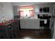 Modern kitchen featuring gray cabinets, stainless steel appliances, and a cozy dining area at 7 Lamplight Ln, Winter Haven, FL 33884
