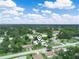 Aerial view shows the home and neighborhood's green landscaping at 715 S Seminole Ave, Fort Meade, FL 33841