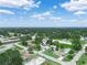 Scenic aerial of a property located within a quiet neighborhood, surrounded by green landscapes and clear blue skies at 715 S Seminole Ave, Fort Meade, FL 33841