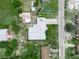 Aerial view of a quaint home showcasing a well-maintained roof and established landscaping at 715 S Seminole Ave, Fort Meade, FL 33841