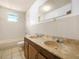 Bathroom featuring a double sink vanity, a tiled shower and bath combination and a window at 715 S Seminole Ave, Fort Meade, FL 33841