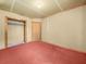 Bare bedroom features clean plastered walls, red carpet, and closet at 715 S Seminole Ave, Fort Meade, FL 33841
