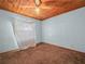 This bedroom features a ceiling fan and blank white wall with carpet at 715 S Seminole Ave, Fort Meade, FL 33841