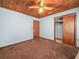 This cozy bedroom features wood ceiling with carpet and an open closet at 715 S Seminole Ave, Fort Meade, FL 33841