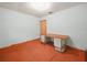 Bedroom with orange carpet and walls painted light blue; includes a desk at 715 S Seminole Ave, Fort Meade, FL 33841