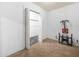 Bedroom featuring beige carpeting, white walls and trim and a walk-in closet at 715 S Seminole Ave, Fort Meade, FL 33841