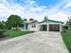 Inviting home featuring a covered carport, lush lawn, and a driveway in a quiet neighborhood at 715 S Seminole Ave, Fort Meade, FL 33841